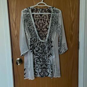 White with black design see through swimsuit cover up. Will fit small-medium